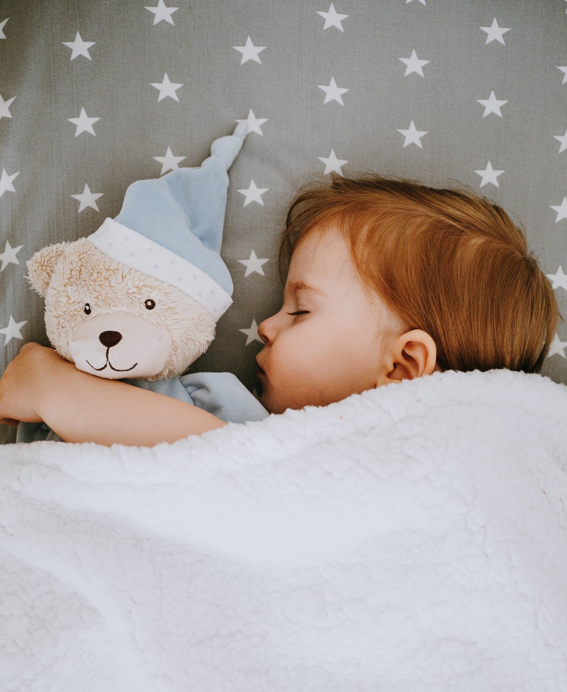 Baby Sleeping with a Teddy Bear